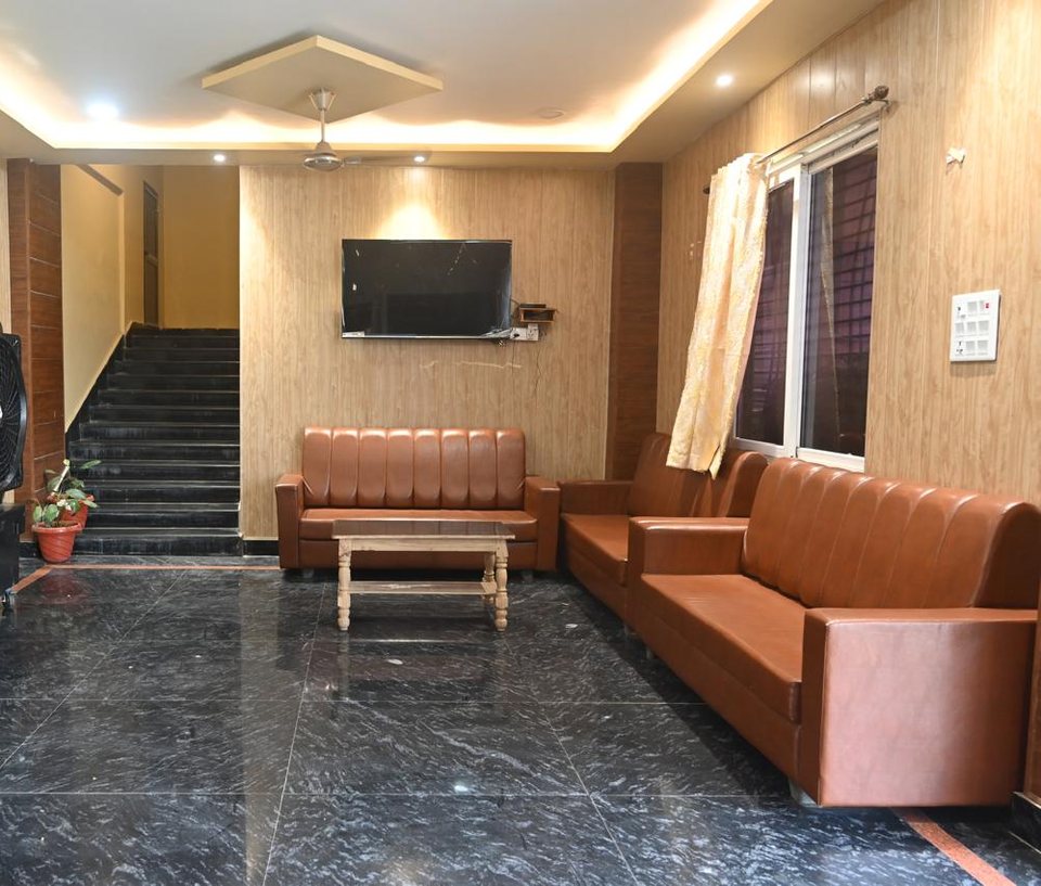 Guest lounge with leather seating and staircase