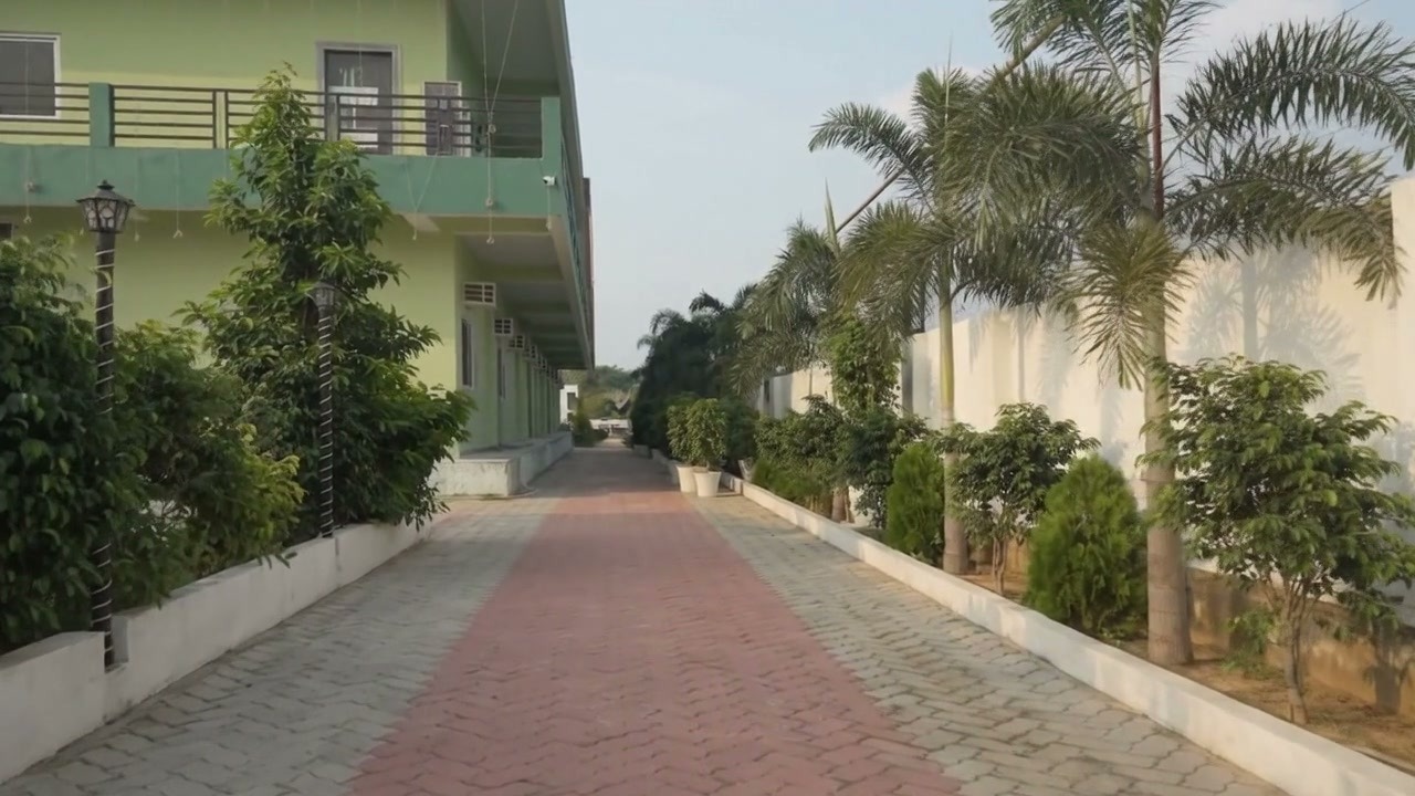 Video preview frame showing Shreya Palace & Resort illuminated entrance and banquet hall